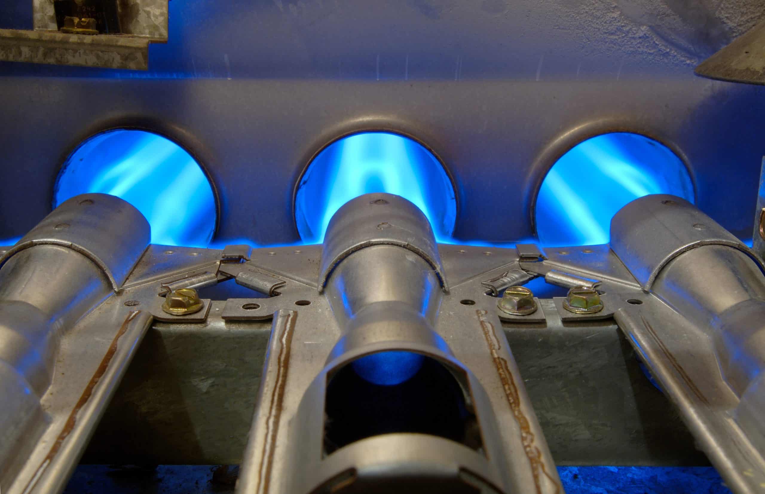 High-quality HVAC gas burners producing blue flames at Nexus Mechanical services in Sedalia, MO.